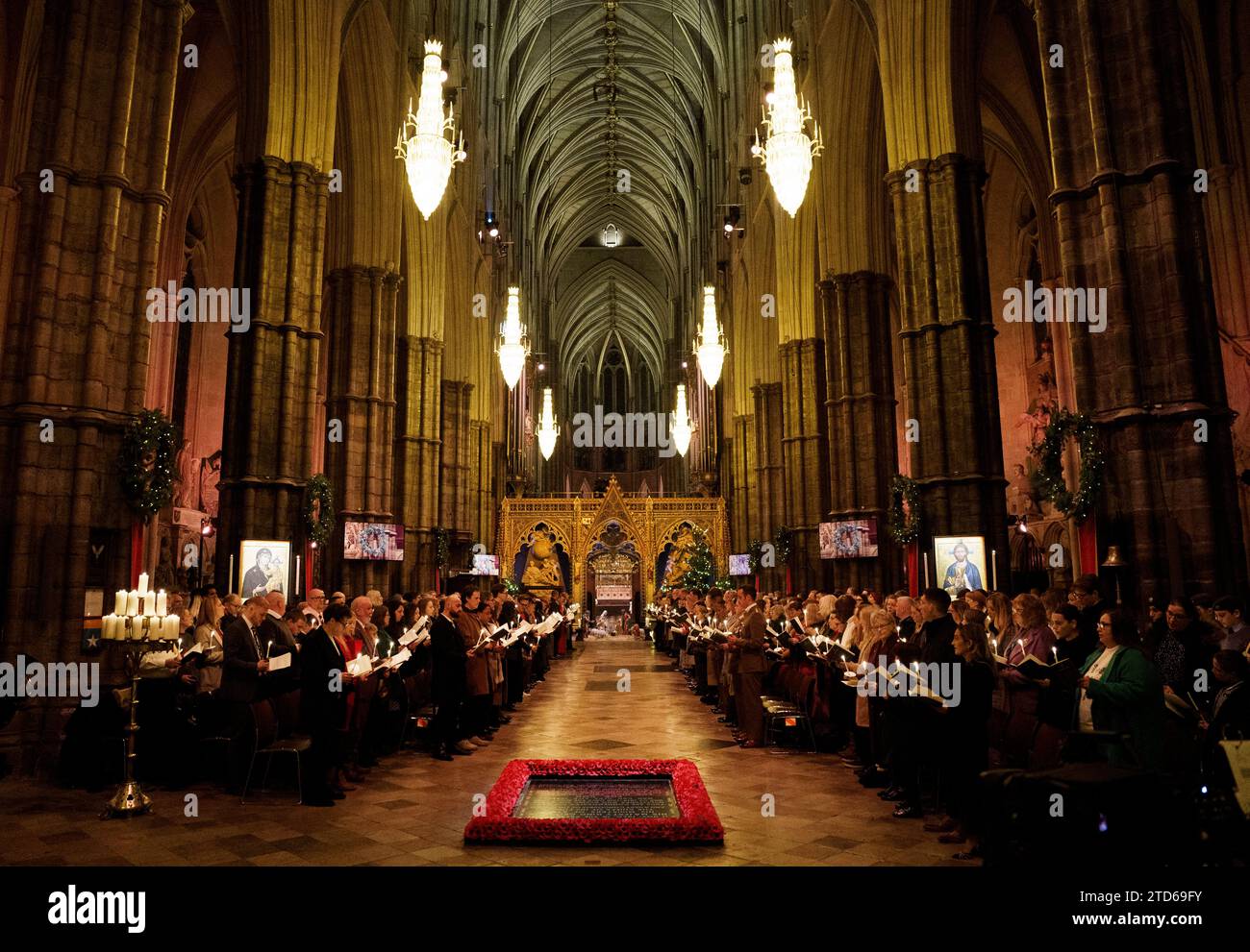 Members of the congregation hold candles during the Royal Carols