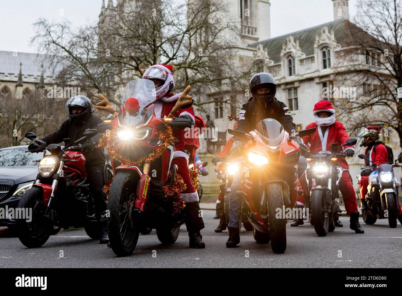 Participants in Santa costumes seen riding their decorated motorbikes ...
