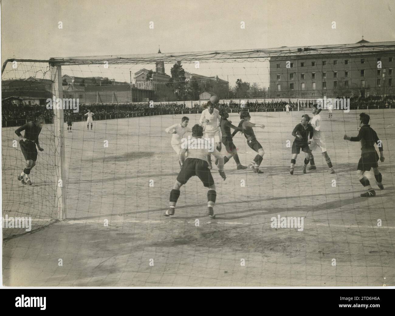 Madrid, 03/07/1920. An important play in the match between the Madrid FC teams that won, and Racing, for the regional championship. A view of the Racing de Madrid field. In the background, buildings on General Martinez Campos Street. The one who finishes with a header is Santiago Bernabéu. Credit: Album / Archivo ABC Stock Photo