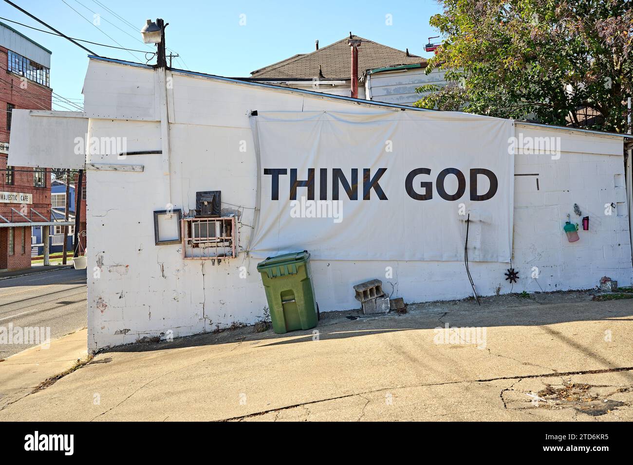 Think God banner sign hanging from the side of a building, a religious or spiritual message in Montgomery Alabama, USA part of the bible belt in USA. Stock Photo