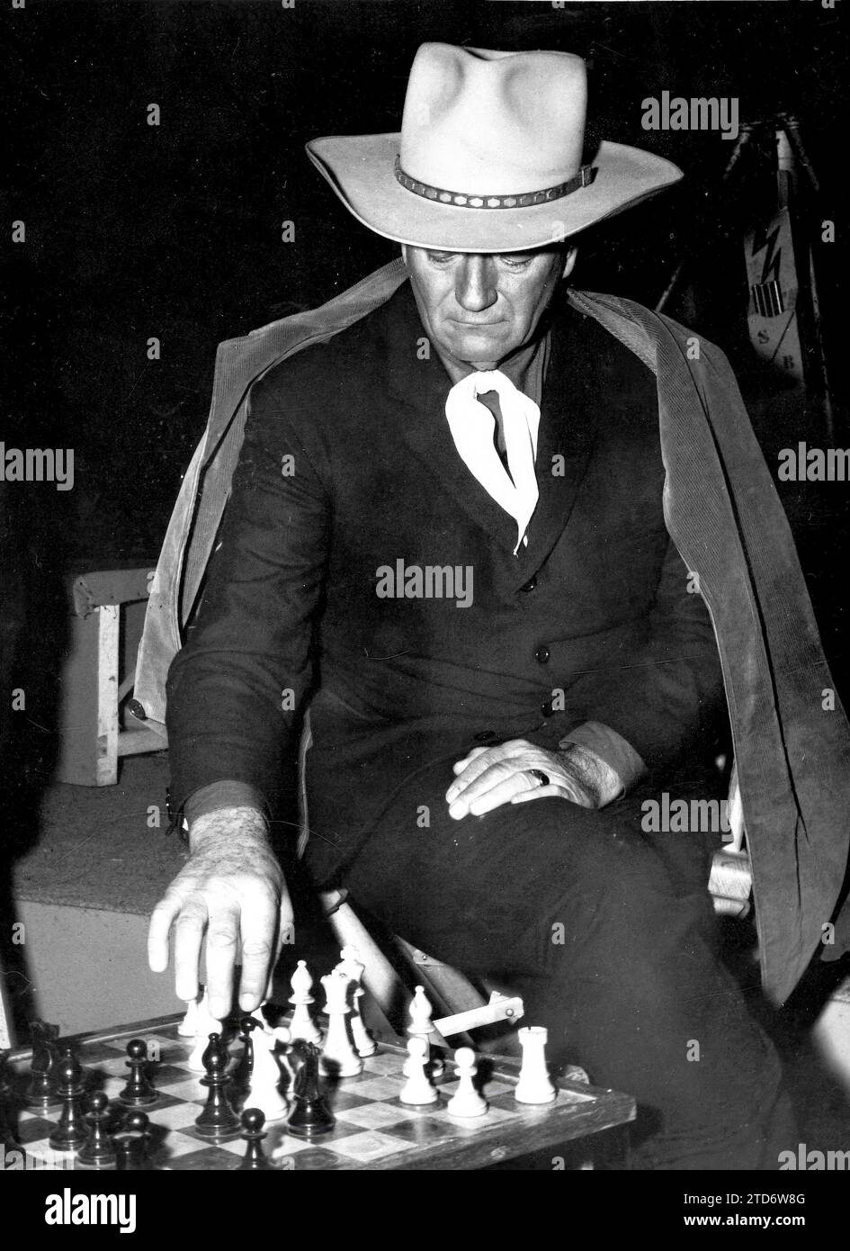 Madrid, 1964. John Wayne playing chess during a break from filming 