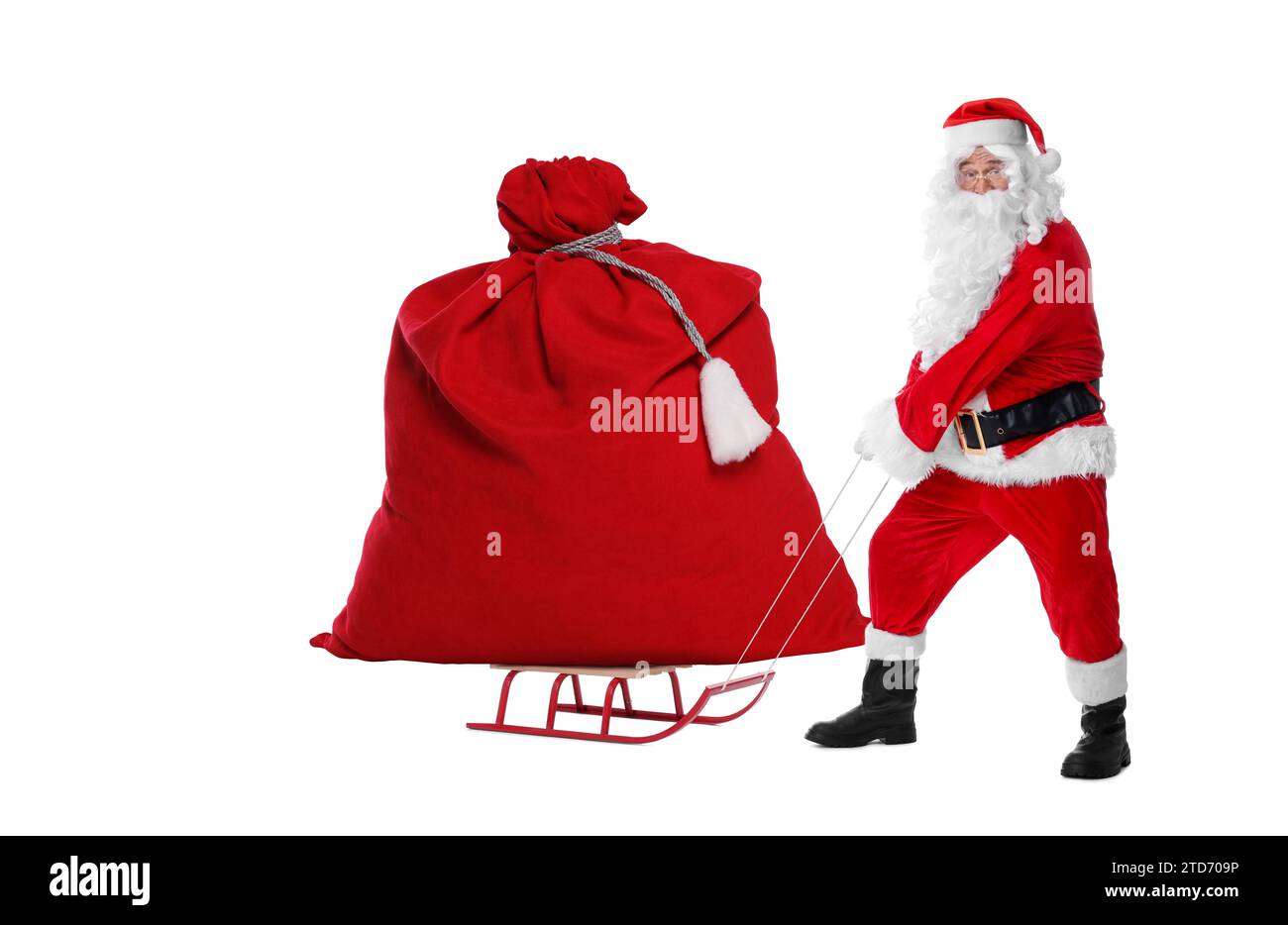 Santa Claus with big red bag full of Christmas presents on sled against ...
