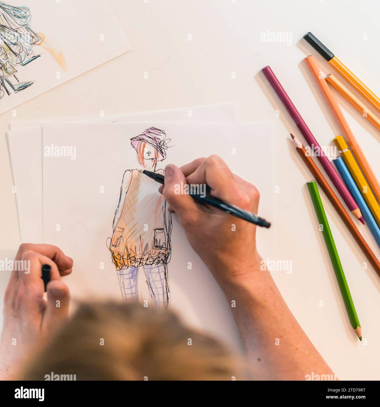 Top view of a fashion designer drawing a fashion sketch Stock Photo - Alamy
