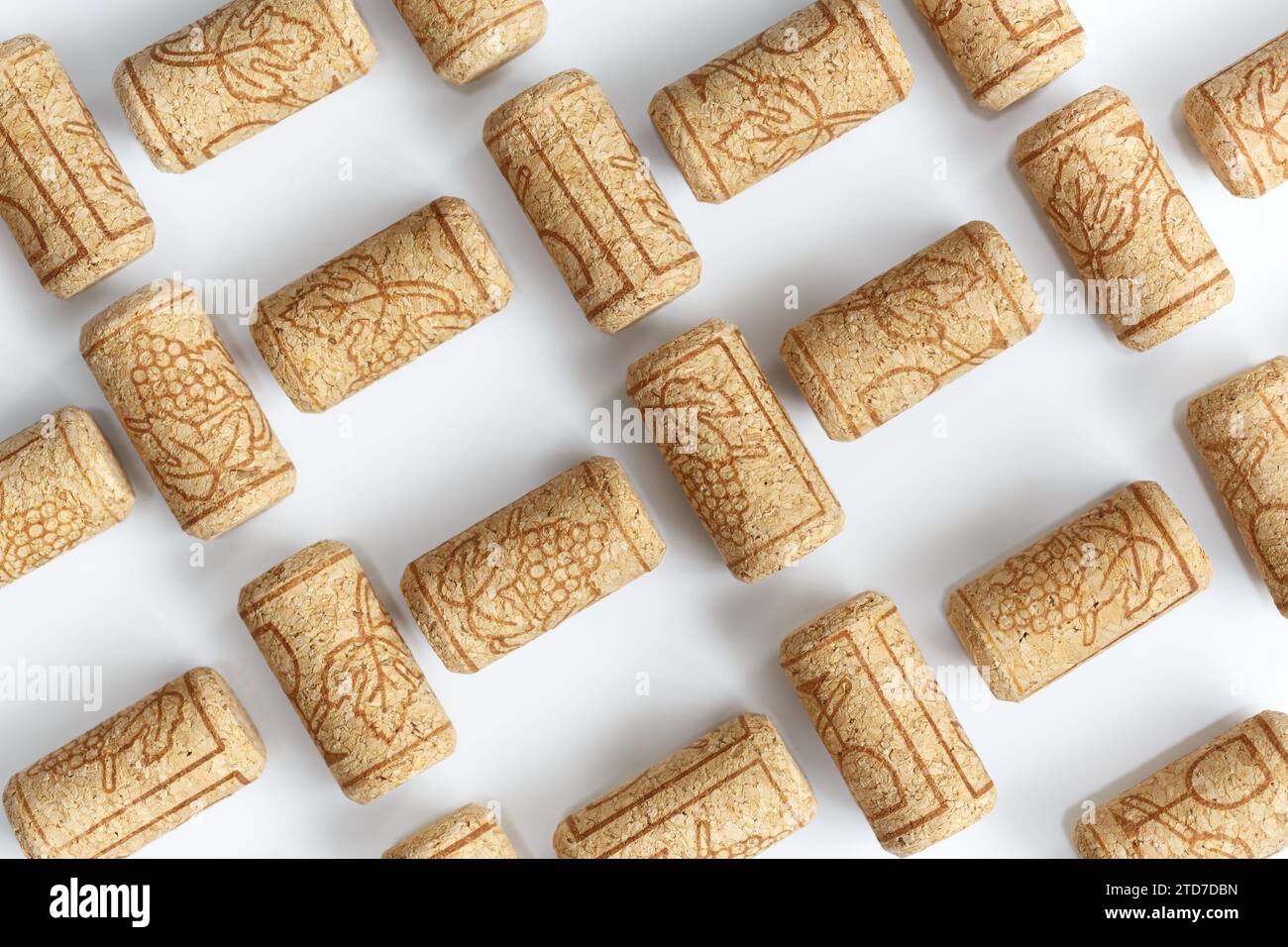Wine corks laid out in a lattice pattern on a white background. Stock Photo