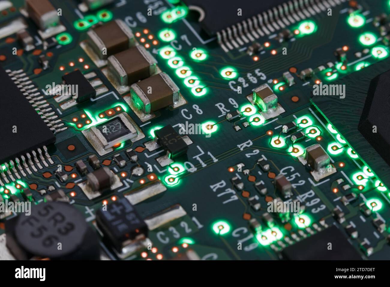 Printed circuit board with various elements, with green illumination. Macro photography Stock Photo