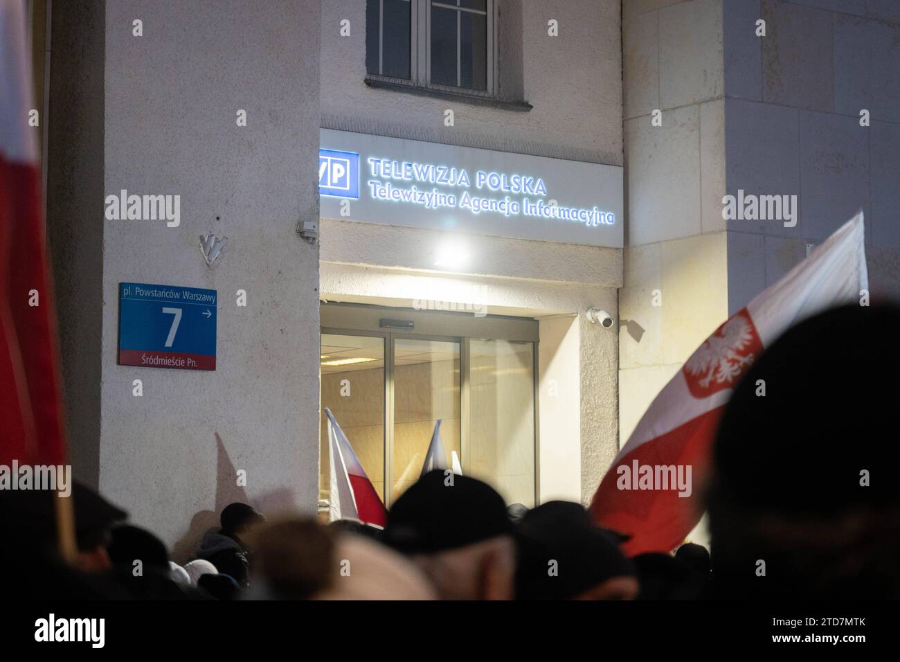 a waving Polish flags and the Polish Television TVP logo in the