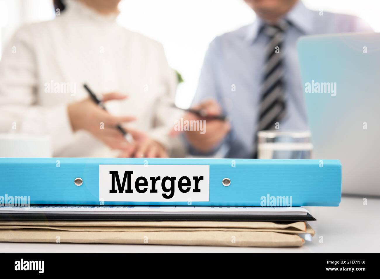 Merger document on desk with manager and board are discuss about merger. Stock Photo
