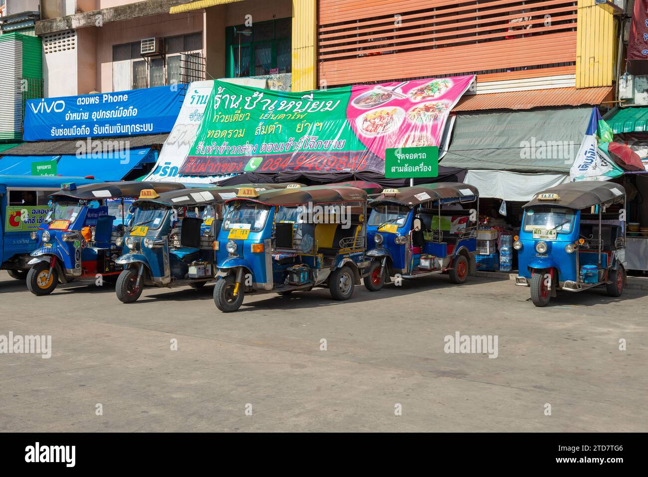 CHIANG RAI, THAILAND - DECEMBER 17, 2018: Group of tuk-tuks (traditional city taxi) waiting for passengers on a sunny day Stock Photo