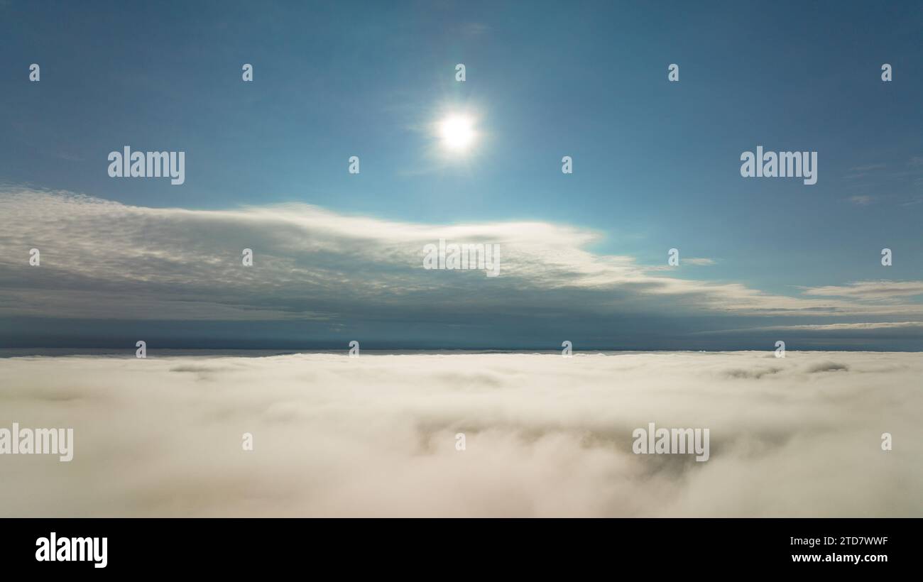 CFlying high above the clouds. Aerial view of clouds and horizon from drone. Thunderclouds from above before rain. Tragic gloomy natural landscape of Stock Photo