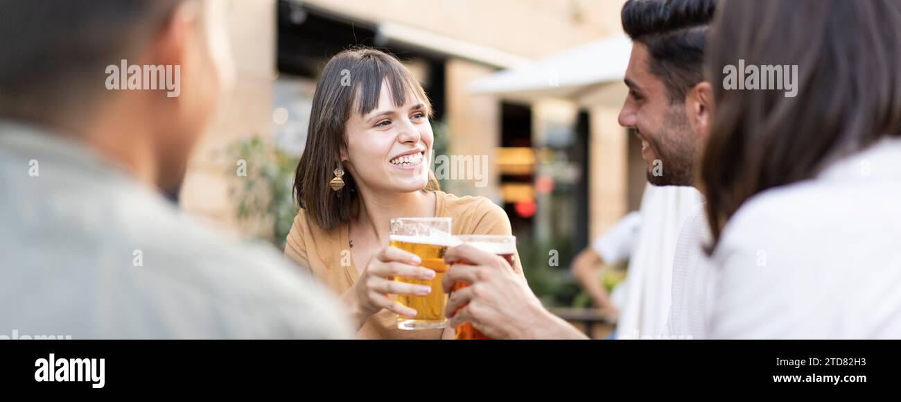 Horizontal banner or header with multiracial friends drinking beer at brewery pub - Genuine friendship life style concept with guys and girls enjoying Stock Photo