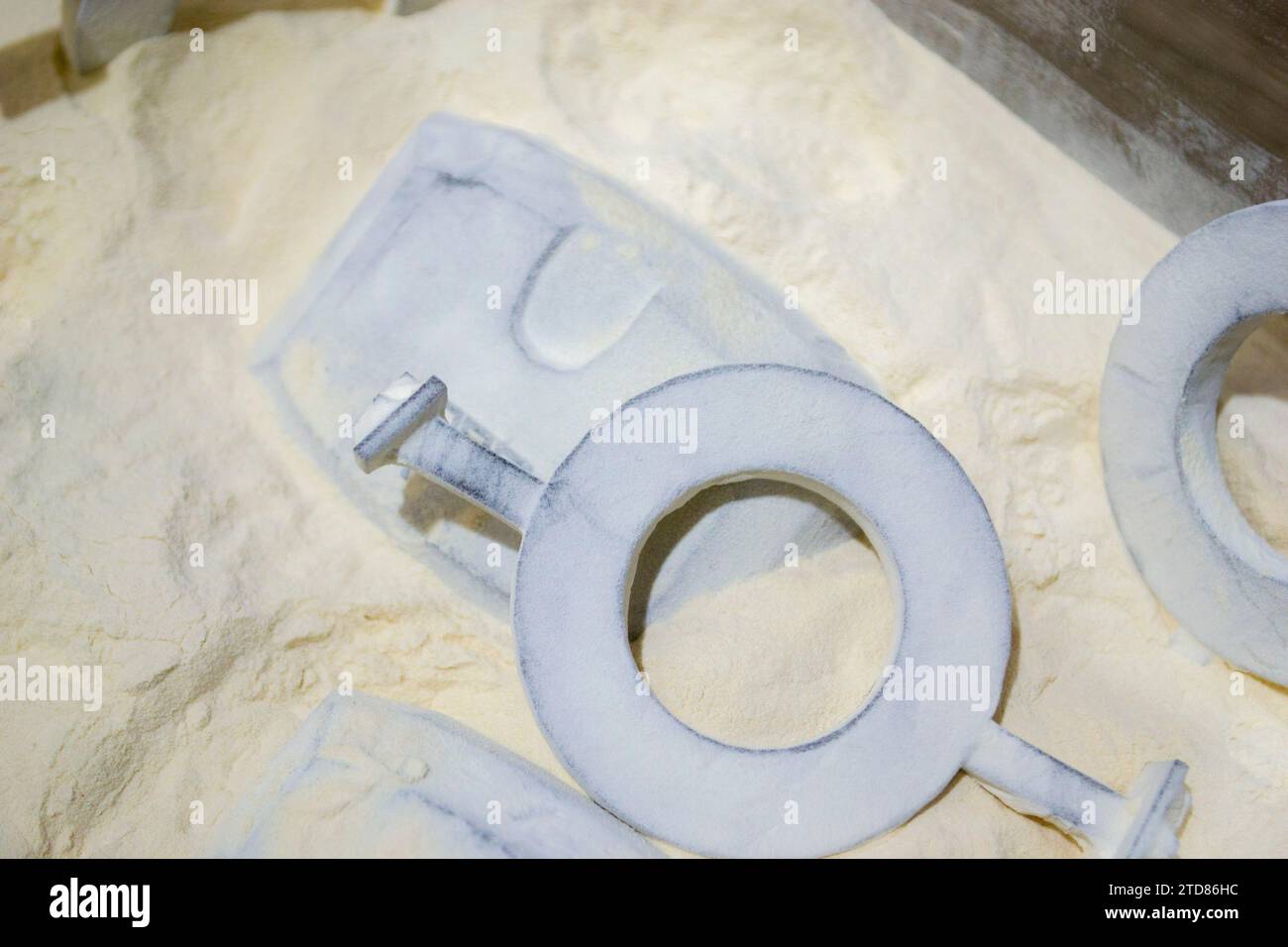 Objects printed on a 3D printer from powdered polyamide lying in white polyamide powder. Models