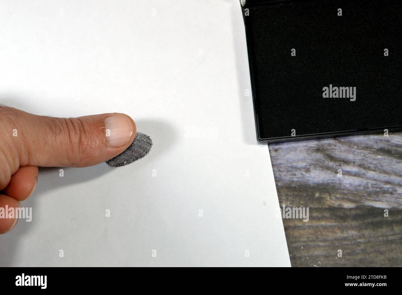 A fingerprint and a black color stamp ink pad, finger print is an