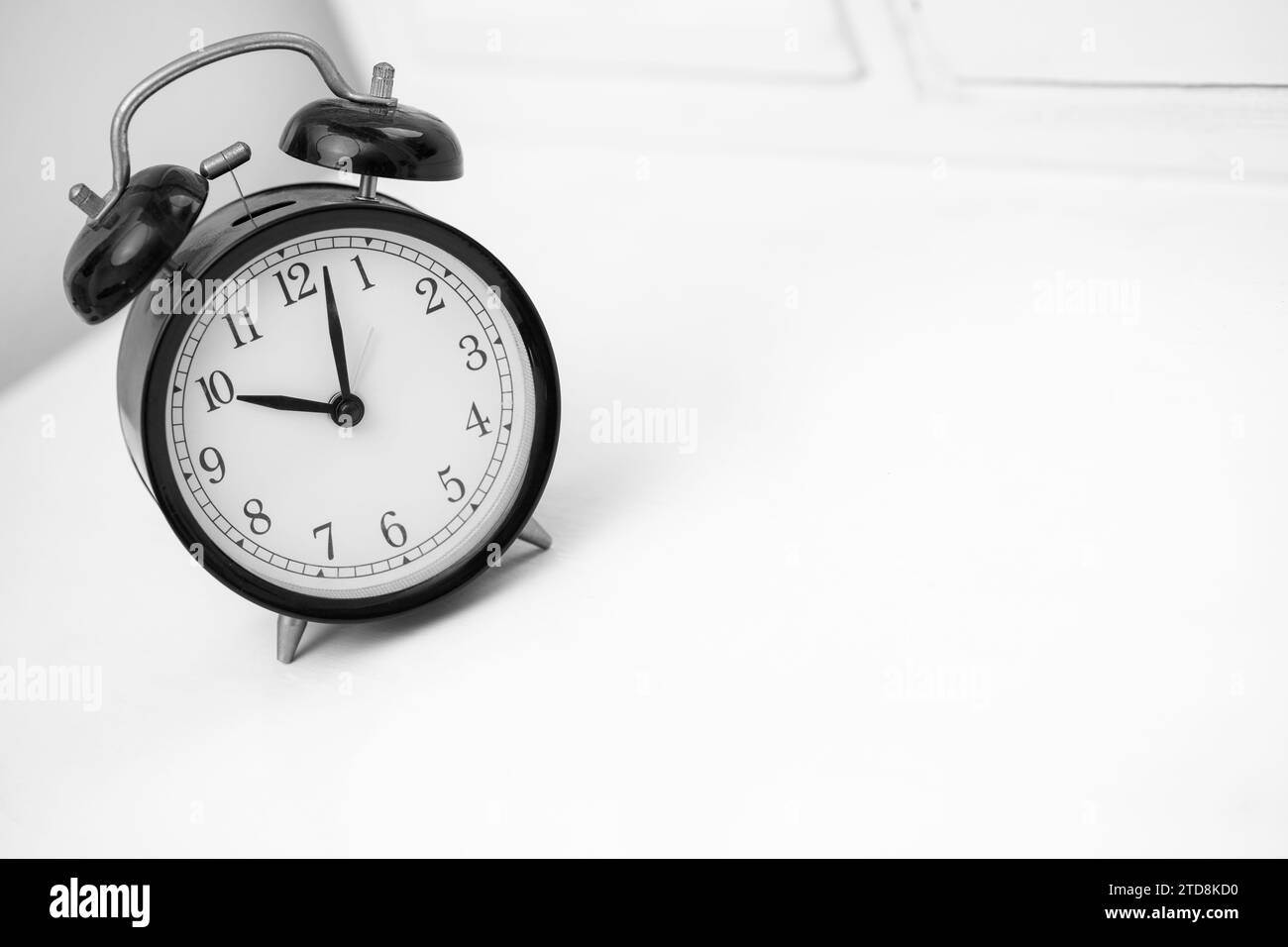 Black retro alarm clock on white background. Copy space Stock Photo