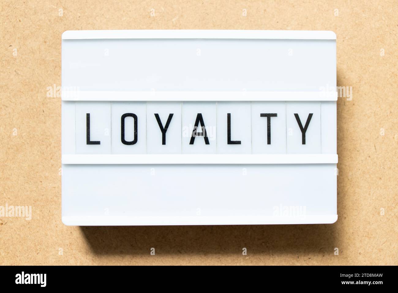 Lightbox with word loyalty on wood background Stock Photo