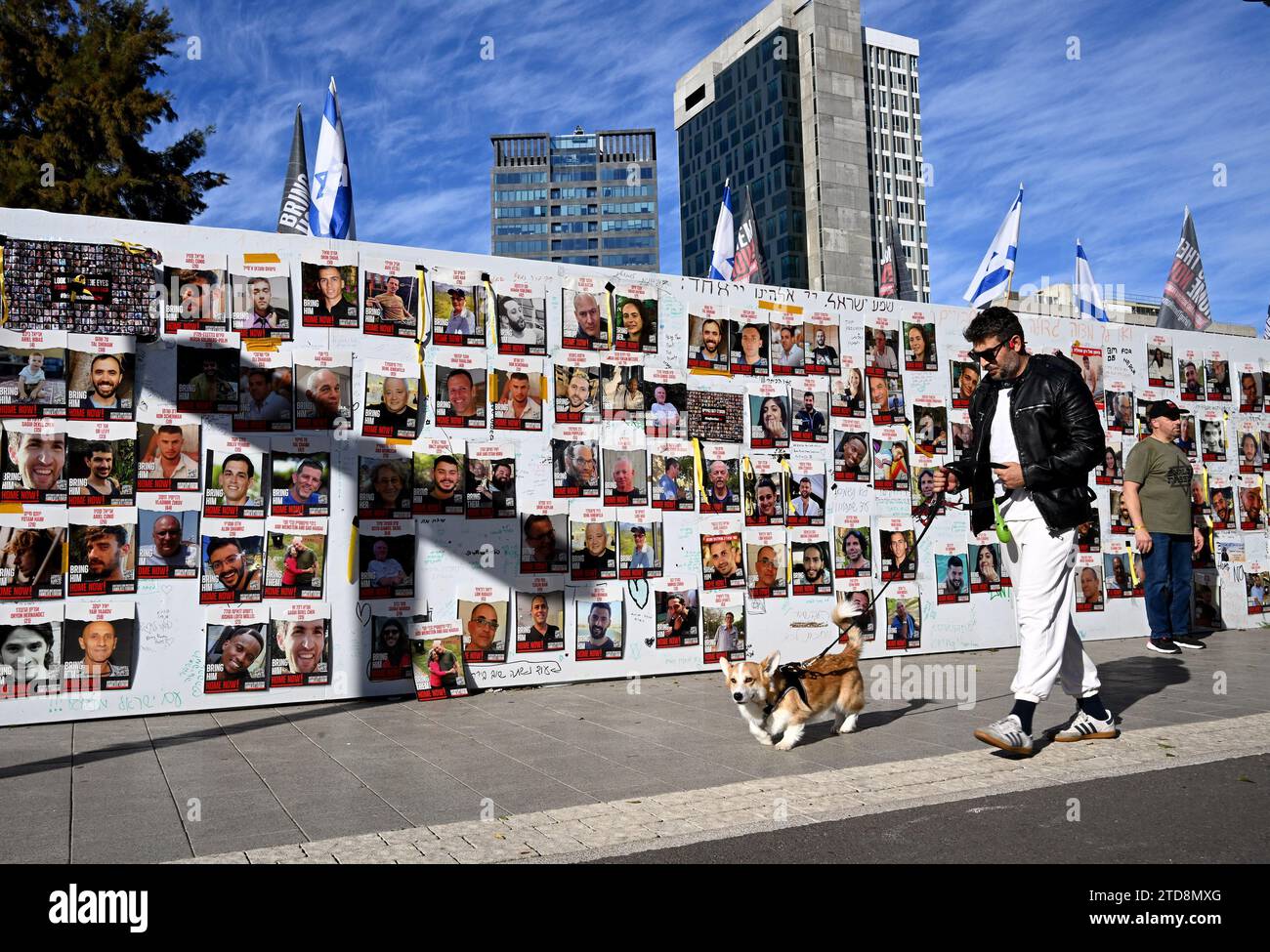 Tel Aviv, Israel. 16th Dec, 2023. A man walks a dog past photos of Israeli hostages held captive by Hamas in Gaza at Hostage Square outside the Tel Aviv Museum in Tel Aviv, on Saturday, December 16, 2023. Israeli forces opened fire, killing three hostages mistaken for Hamas. Photo by Debbie Hill/ Credit: UPI/Alamy Live News Stock Photo