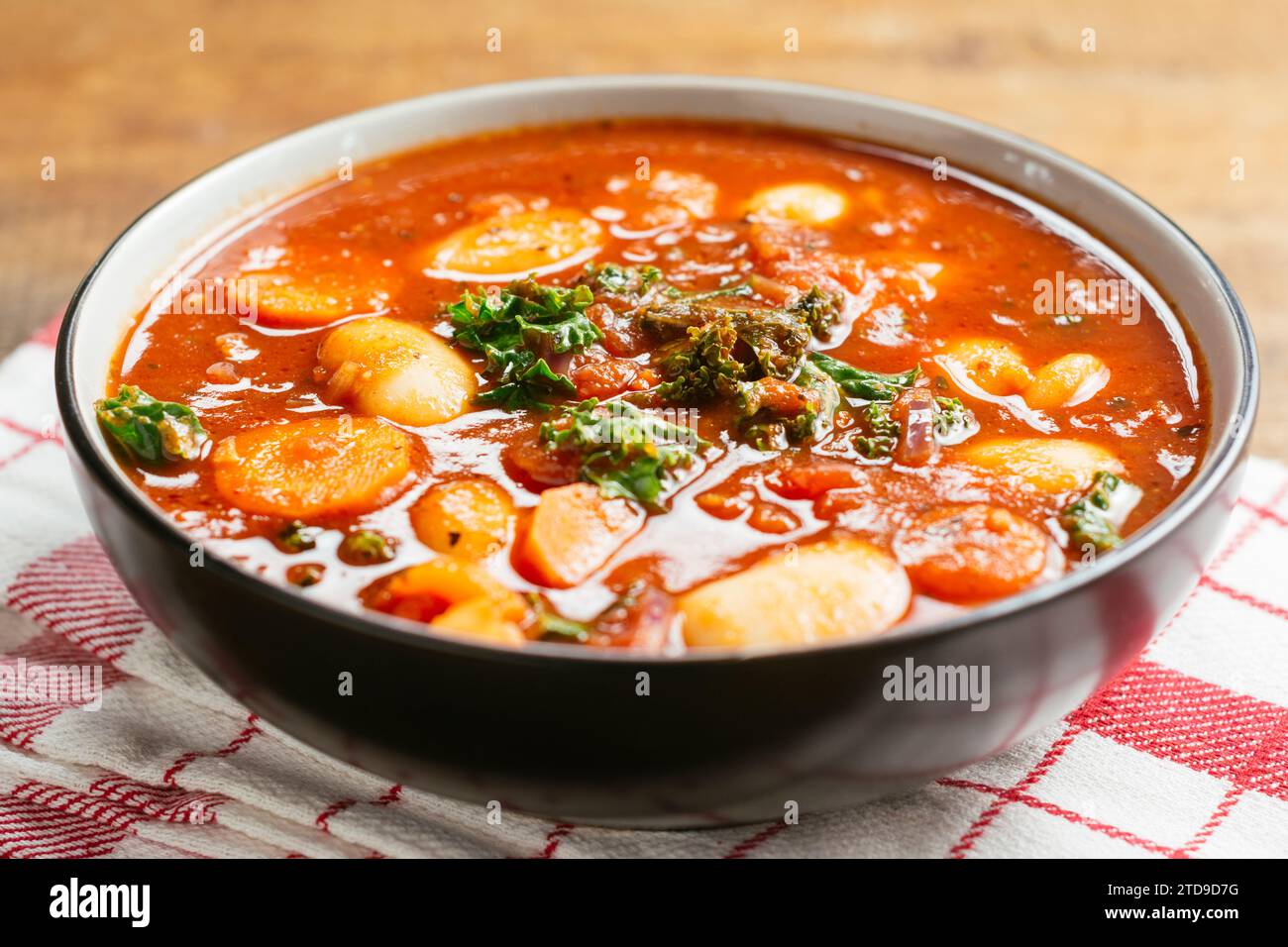 Giant bean soup with kale, carrots and potatoes Stock Photo
