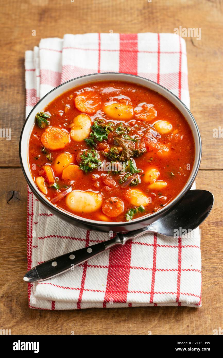 Giant bean soup with kale, carrots and potatoes Stock Photo