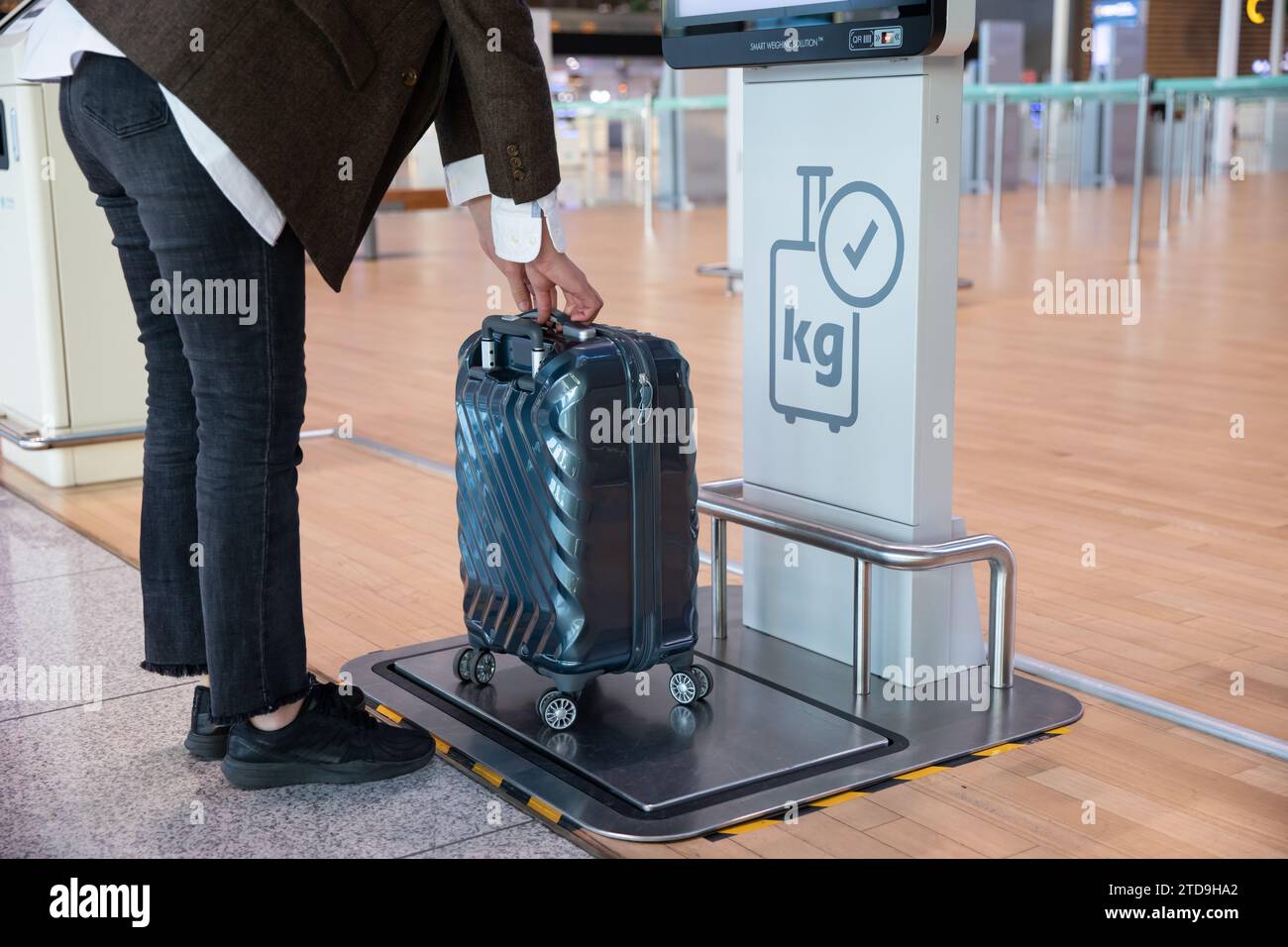 Weighing the luggage using a luggage measuring device at Incheon International Airport in April 2022 Stock Photo