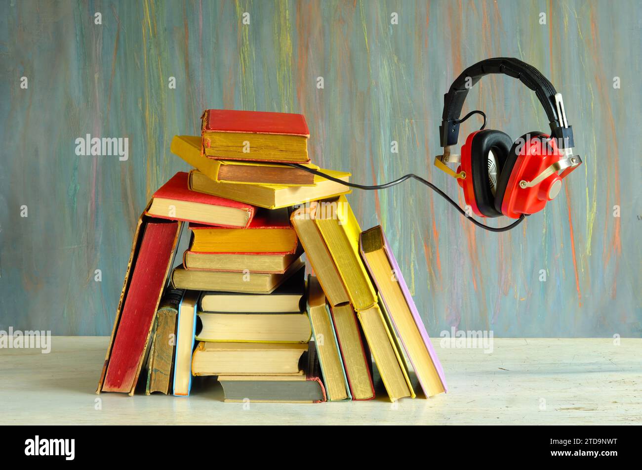 audio book concept with heap of books and floating vintage headphones, literature,education,entertainment, free copy space Stock Photo