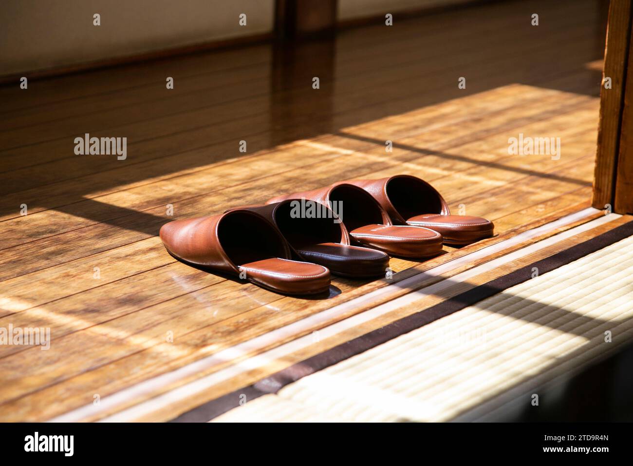 Domestic leather slippers at the entrance of a Japanese house with wooden floors. Stock Photo