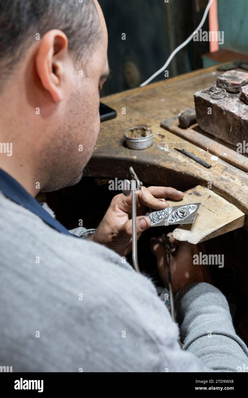 Argentina, San Antonio de Areco, Historic Museo Draghi (Gaucho and silver museum) Silversmith working on custom flatware. Stock Photo