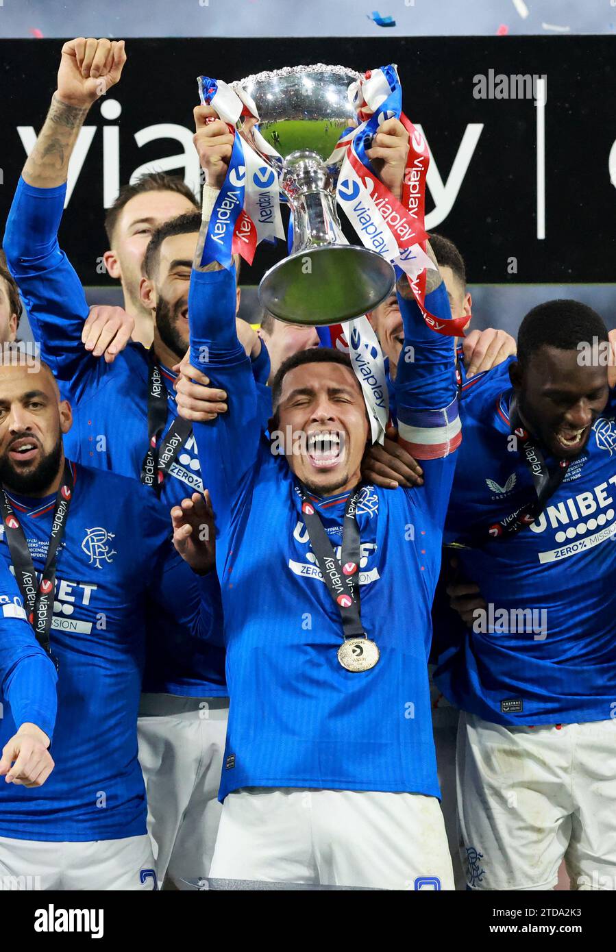 Rangers' James Tavernier lifts the trophy as Rangers' players celebrate