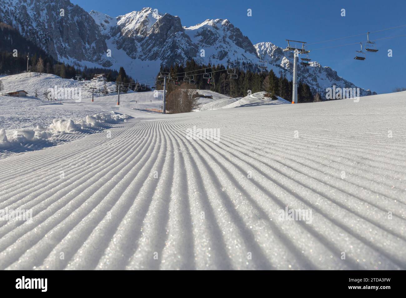 Well-prepared ski slopes and ski lift in the background in mountains in the Alps. Austria Stock Photo