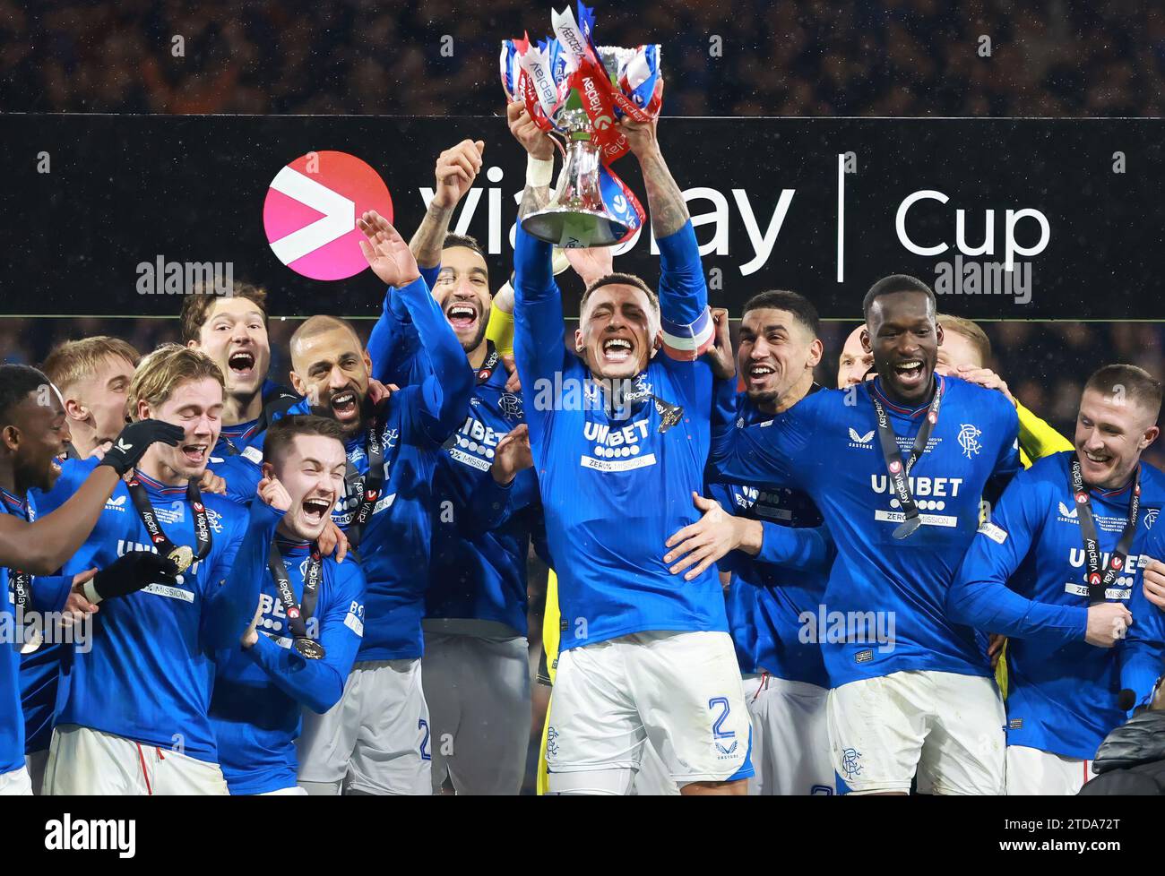 Rangers' James Tavernier lifts the trophy as Rangers' players celebrate