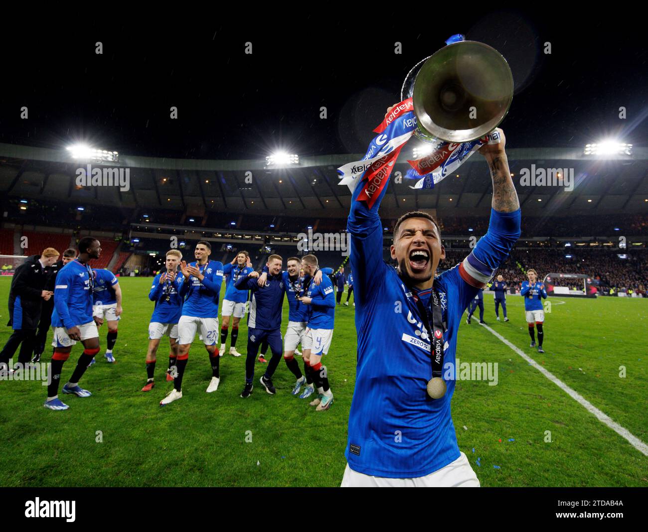 Rangers' James Tavernier lifts the trophy as Rangers' players celebrate