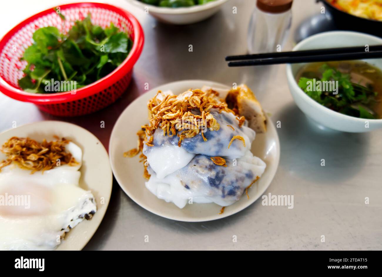 Banh cuon, a Vietnamese steamed rice roll dish at street food stall. A ...