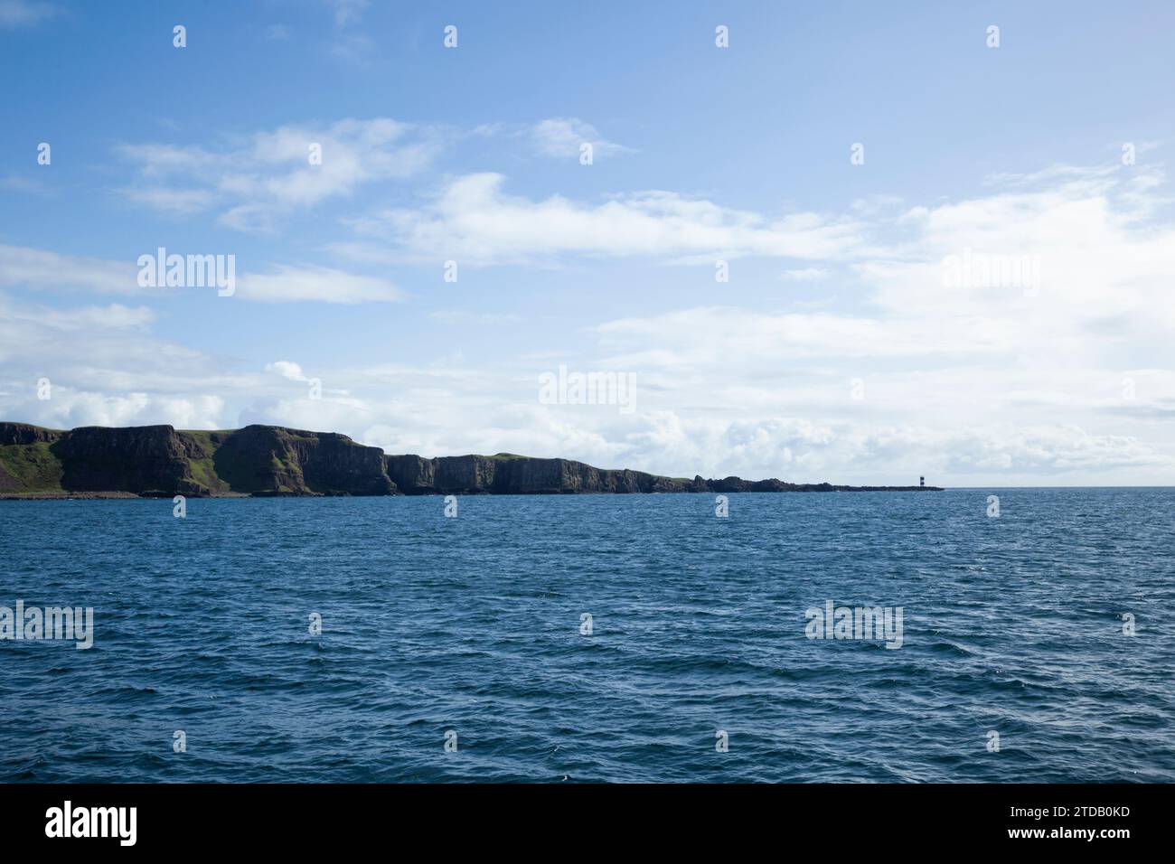 Rue Point on Rathlin Island with Fair Head in the distance. County Antrim, Northern Ireland. Stock Photo