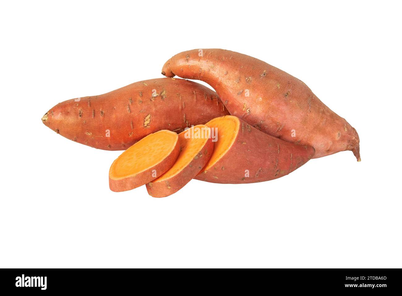 Sweet potato or boniato two whole and one sliced tubes with red skin and yellow flesh isolated on white. Vegetable food staple. Stock Photo