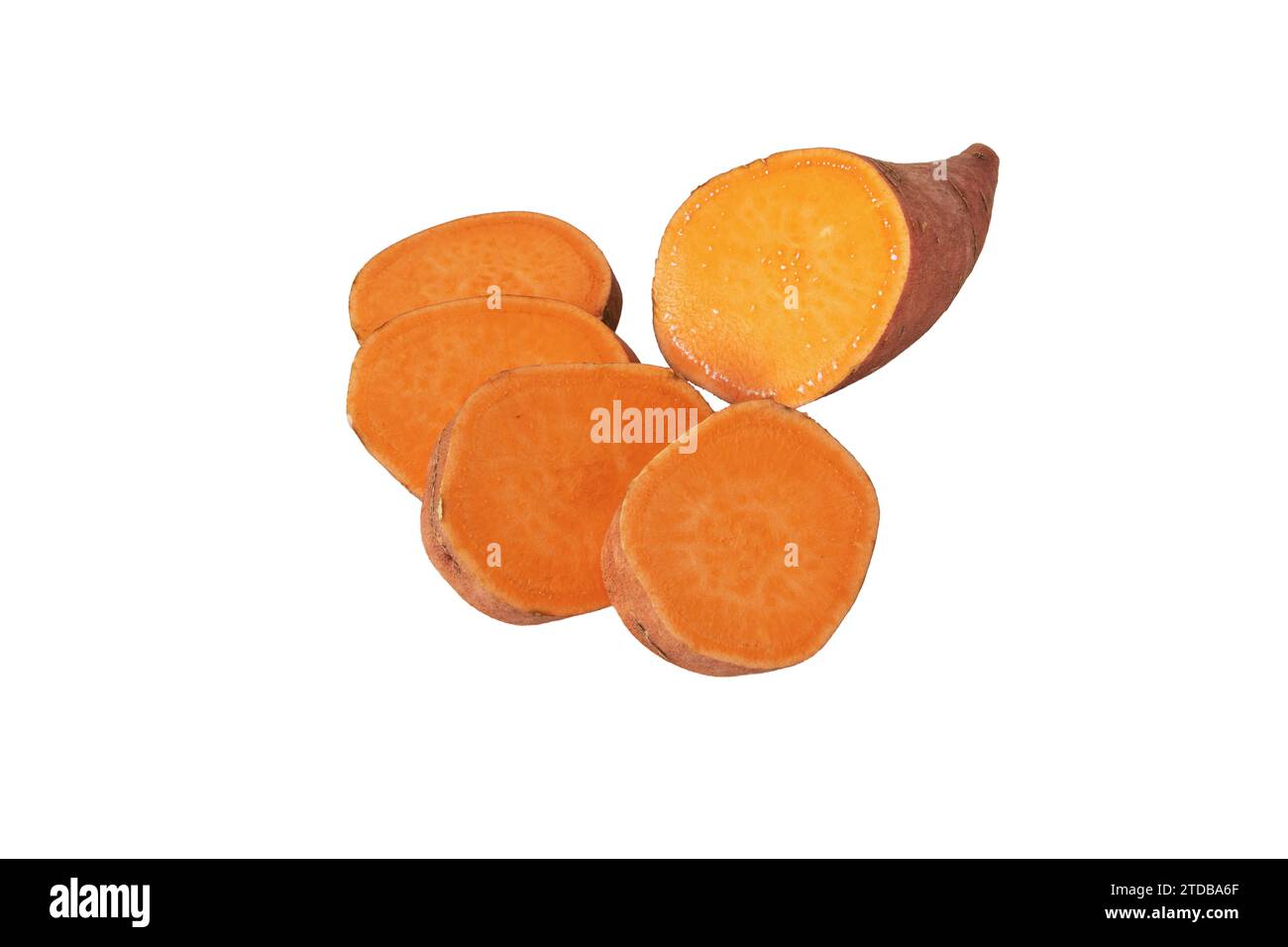 Sweet potato or boniato sliced tube with red skin and yellow flesh isolated on white. Vegetable food staple. Stock Photo