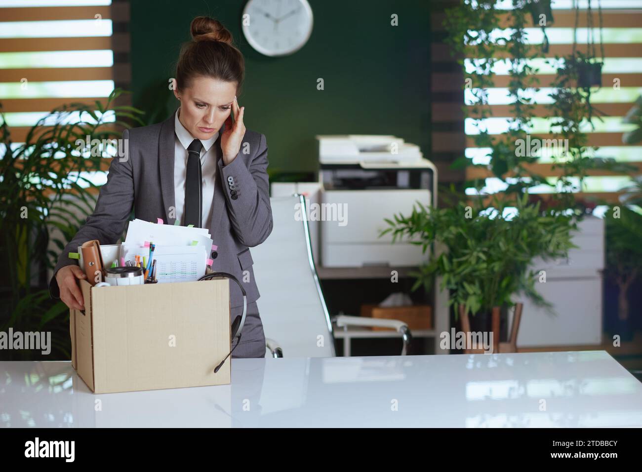 New job. concerned modern female employee in modern green office in ...