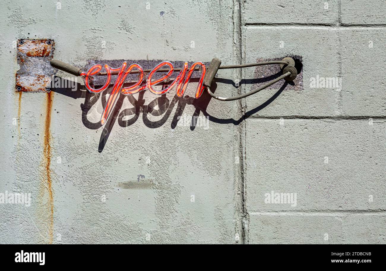 red neon open sign on an exterior wall Stock Photo