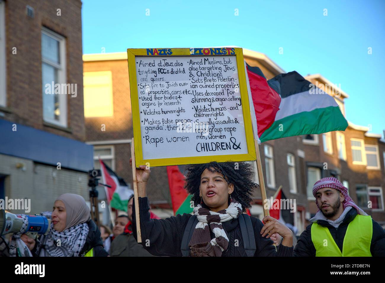 The Hague, South Holland, Netherlands. 17th Dec, 2023. A pro-Palestinian demonstrator carries a protest sign. On December 17, 2023, hundreds of pro-Palestinian demonstrators marched 21 kilometres from Leiden to the International Criminal Court. The demonstrator's message was solidarity with Palestinians who are killed and displaced in Gaza. (Credit Image: © James Petermeier/ZUMA Press Wire) EDITORIAL USAGE ONLY! Not for Commercial USAGE! Credit: ZUMA Press, Inc./Alamy Live News Stock Photo