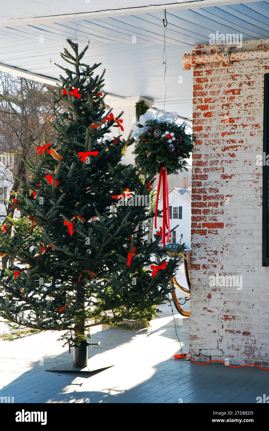 A Christmas tree stands on the porch of a pub in New England Stock Photo