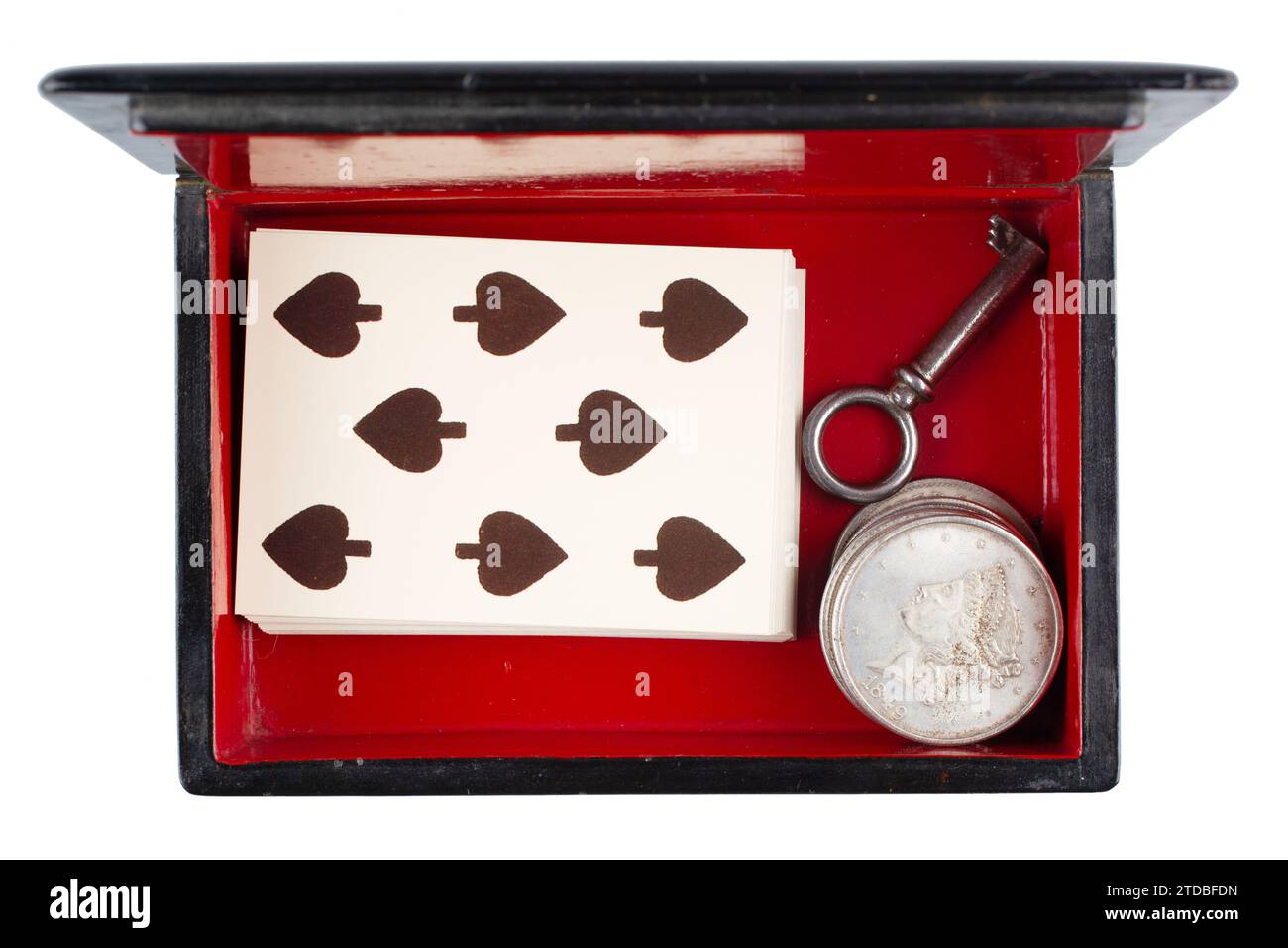 vintage old black and red casket with vintage playing cards and silver dollar coins isolated on white background Stock Photo