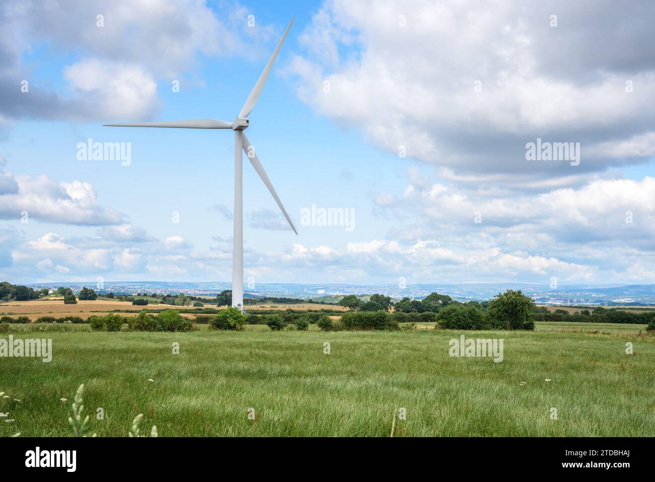 Wind turbine in a rural landscape on a sunny summer day Stock Photo