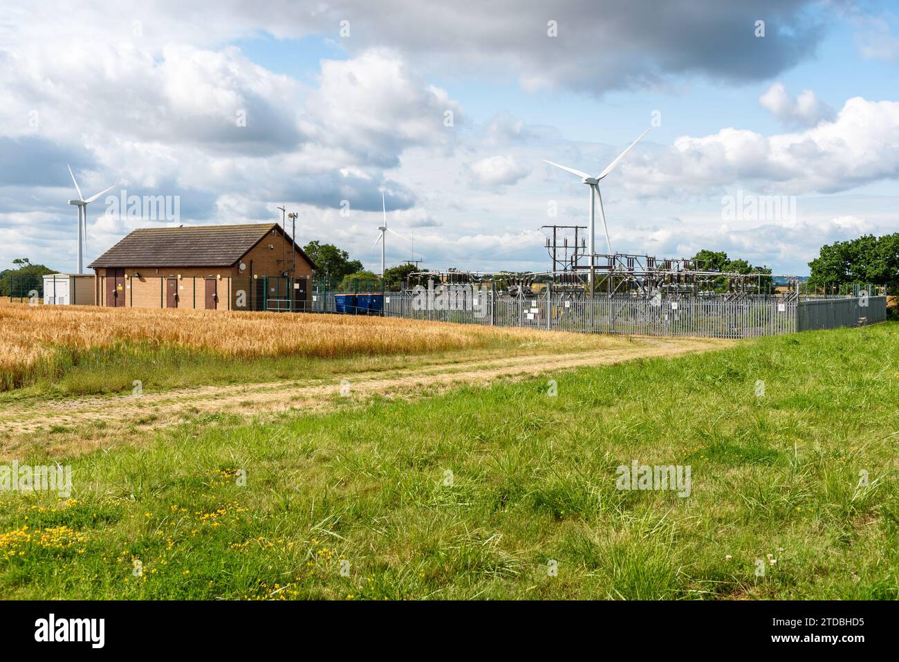 Electrical substation with a wind farm in background in the English countryside on a sunny summer day Stock Photo