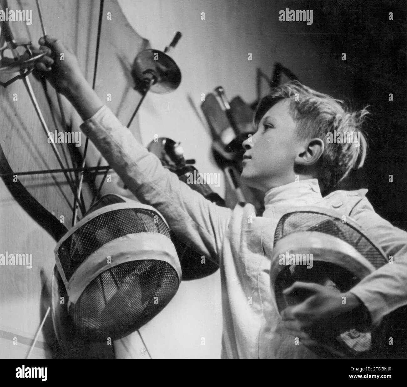 Germany, January 1944. A young boy selecting the foil he will use for fighting, in one of the numerous fencing schools that existed in the country during World War II. Credit: Album / Archivo ABC Stock Photo