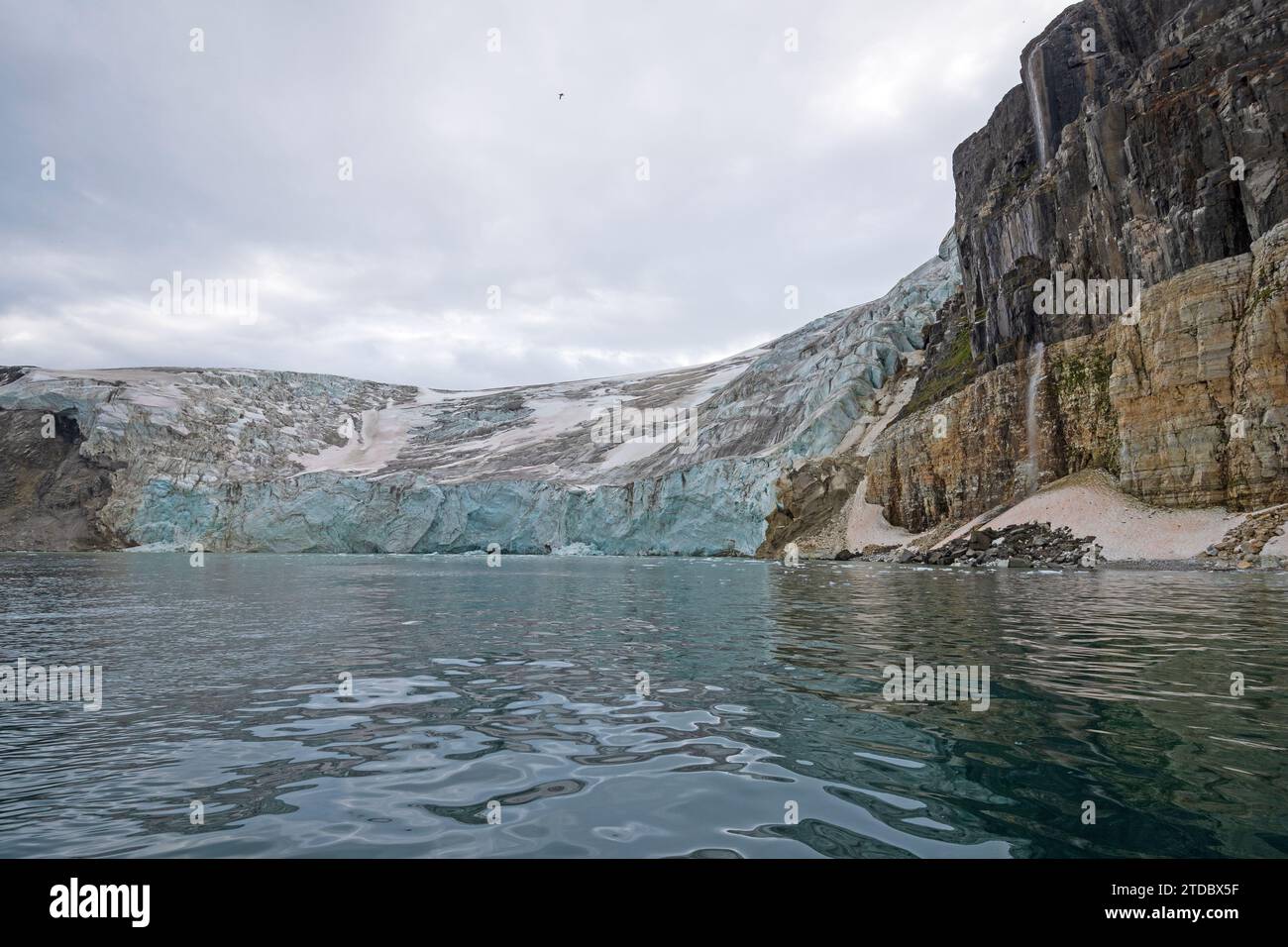 Massive Glacier Flowing Down to the Sea at Alkefjellet in the Hinlopen Strait in the Svalbard Islands Stock Photo