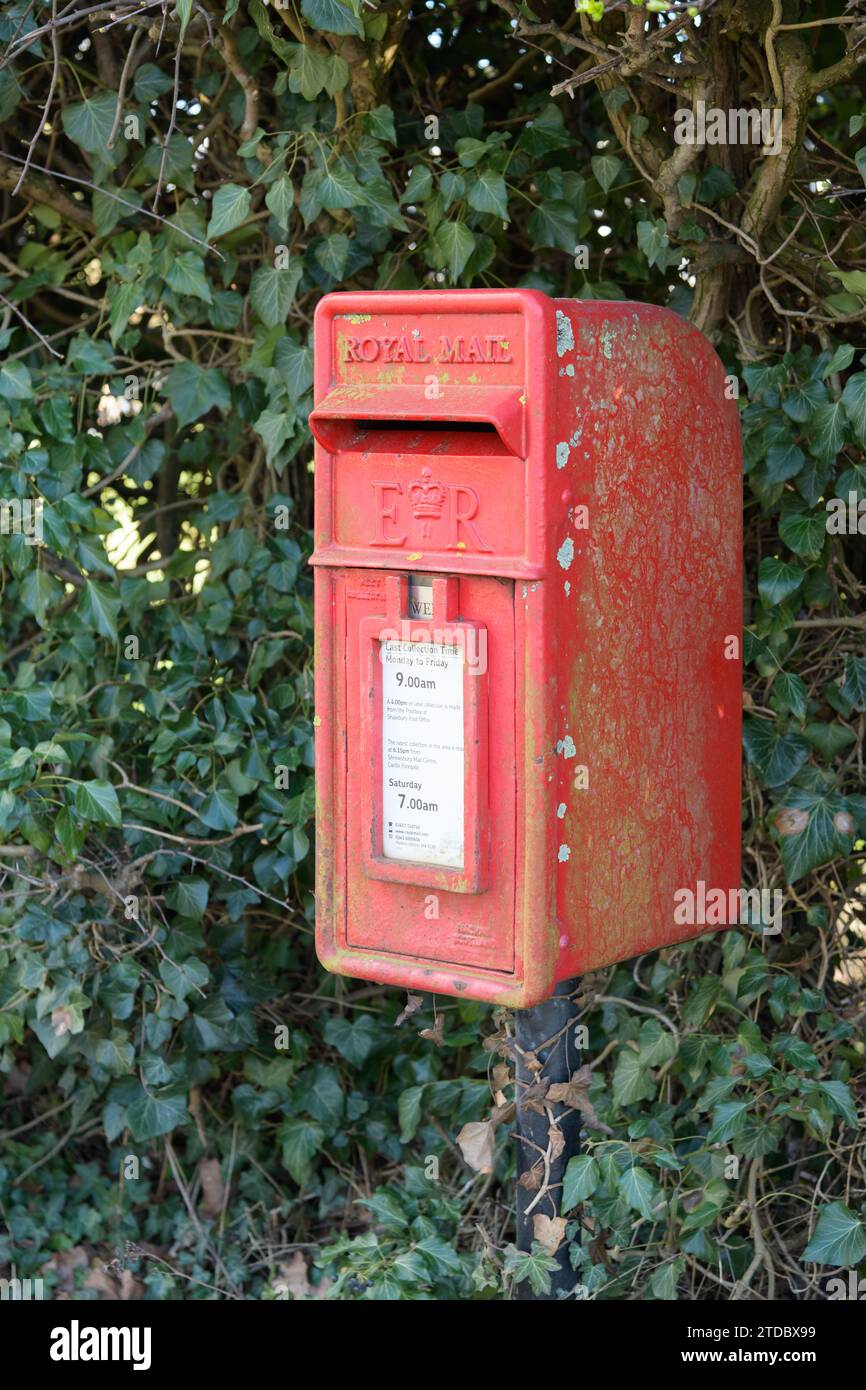 Shawbury, UK - March 7, 2023; Rural red Royal Mail letter box with Queen Elizabeth Royal Cypher Stock Photo