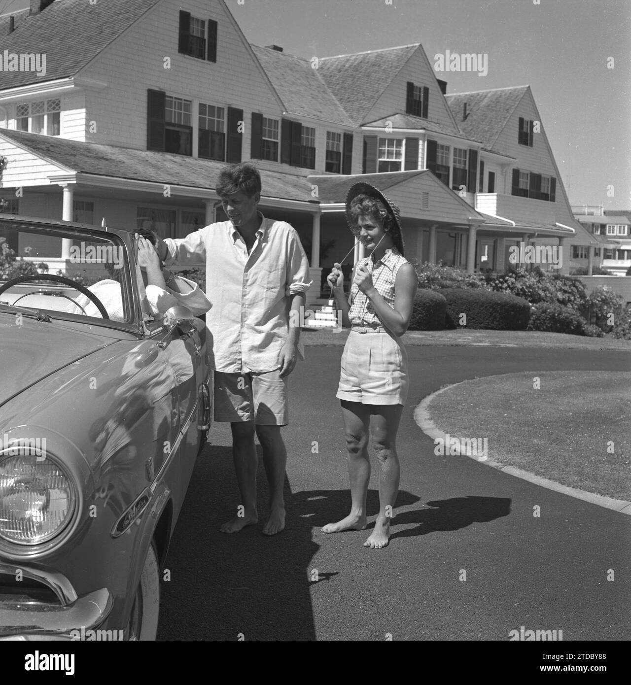 HYANNIS PORT, MA  - JUNE 1953:  Senator John F. Kennedy and fiance Jacqueline Bouvier chat with Patricia Kennedy (at the wheel) while on vacation at the Kennedy compound in June 1953 in Hyannis Port, Massachusetts. (Photo by Hy Peskin) Stock Photo