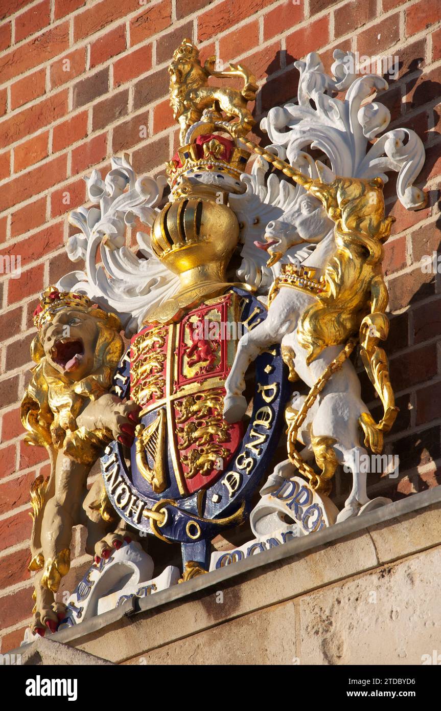 The Royal Coat of Arms of the Monarch of the United Kingdom, above the