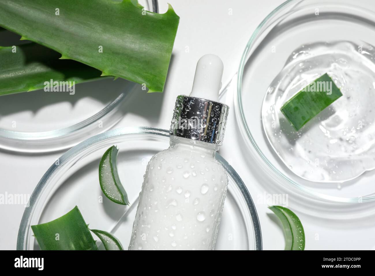 Flat lay composition with cosmetic products and cut aloe vera on white ...