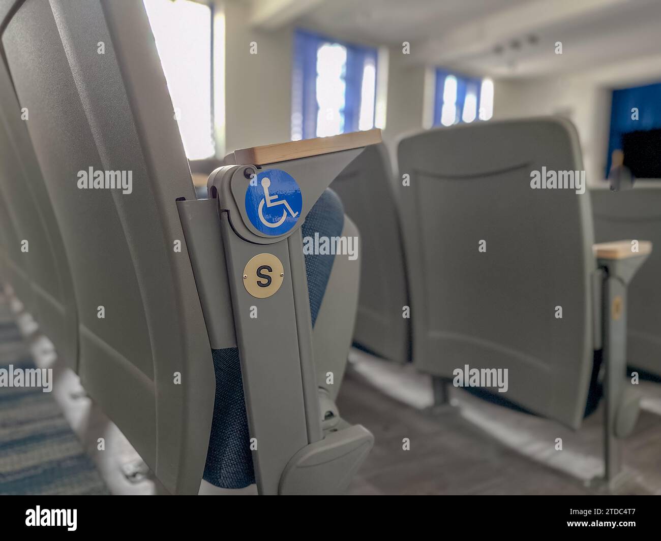 Close up image of empty ADA, accessible, gray and blue theater ...