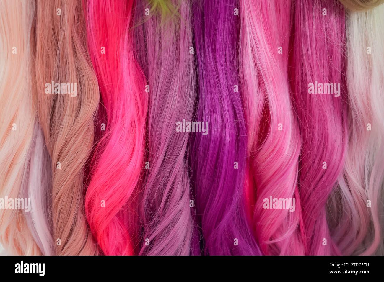 Hair samples of different colors palette. Different hair bright rich tint colors - pink, crimson, orange. Various hair colors set background close up Stock Photo