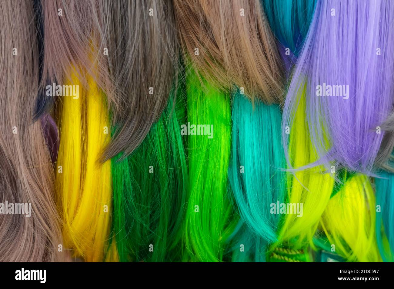 Hair samples of different colors palette. Different hair bright rich tint colors - green, yellow, turquoise. Various hair colors set background close Stock Photo