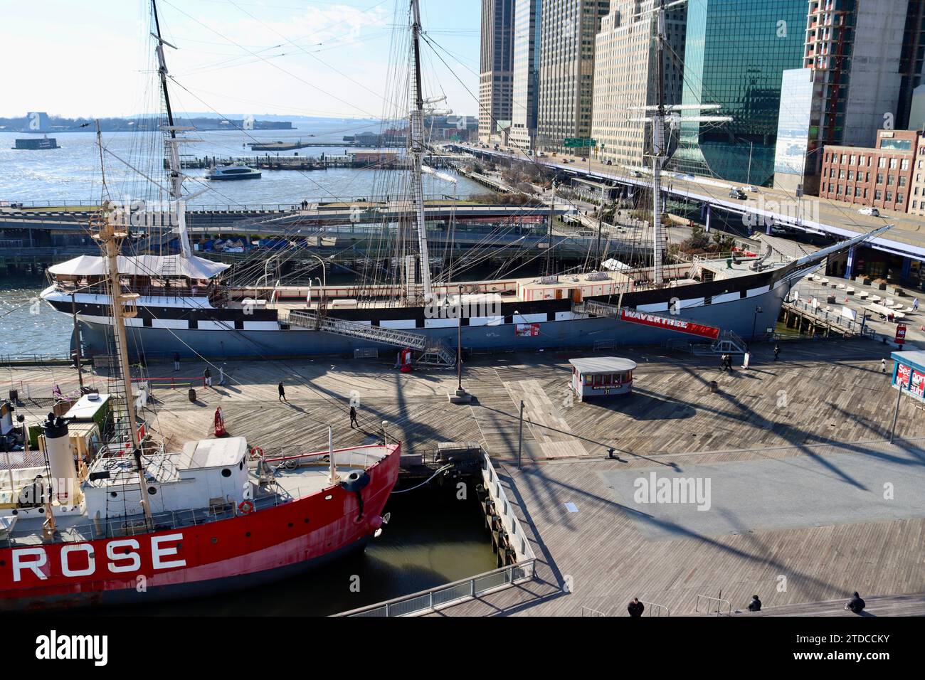 The old museum ships at South Street Seaport with FDR drive and the Financial District in the background at lower Manhattan, New York Stock Photo